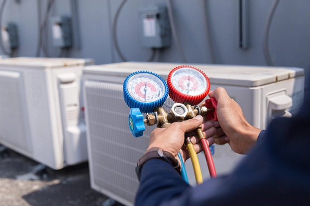 Checklist on clipboard resting atop indoor air handler during seasonal maintenance visit